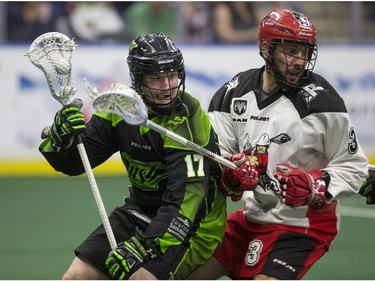 Saskatchewan Rush forward Robert Church moves the ball against Calgary Roughnecks defence Dan MacRae in NLL action on Saturday, April 2nd, 2016.