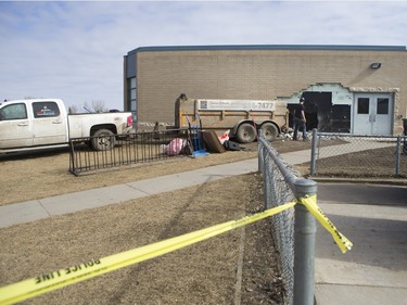 The Saskatoon Police Collision Analyst Unit and workers on the scene of Silverspring School on Sunday, April 3, 2016. Earlier in the morning a 25 year driver went over an embankment and collided with the school.