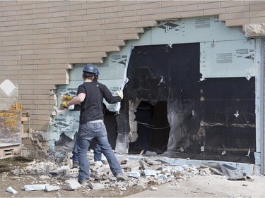 The Saskatoon Police Collision Analyst Unit and workers on the scene of Silverspring School on Sunday, April 3, 2016. Earlier in the morning a 25 year driver went over an embankment and collided with the school.