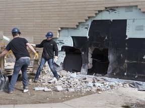 The Saskatoon Police Collision Analyst Unit and workers on the scene of Silverspring School on April 3, 2016. Earlier in the morning a 25-year-old driver went over an embankment and collided with the school.