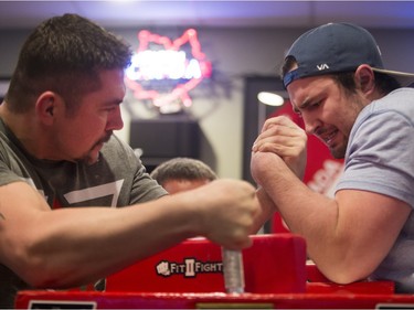 Clayton Turcotte (L) and Darnell Wojocichowski battle during the World Armwrestling League on ESPN's 2016 Super Qualifier tournament at Bugsy's Sports Bar at Lawson Heights Mall on April 9, 2016.