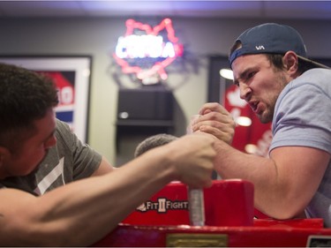 Clayton Turcotte, left, and Darnell Wojocichowski battle during the World Armwrestling League on ESPN's 2016 Super Qualifier tournament at Bugsy's Sports Bar at Lawson Heights Mall on Saturday, April 9th, 2016.