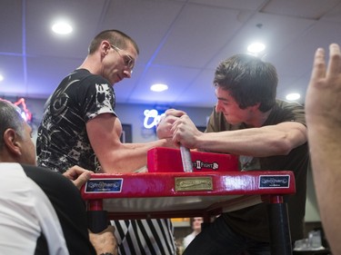 Garth Green (L) and Jayden Borstmayer battle during the World Armwrestling League on ESPN's 2016 Super Qualifier tournament at Bugsy's Sports Bar at Lawson Heights Mall on April 9, 2016.