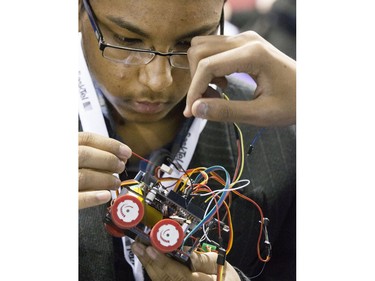 Rafia Khan of Bedford Road High School in Saskatoon fine tuning his robot preparing to do battle at the eighth annual Polytechnic Sumobot Robot Rumble, April 14, 2016.