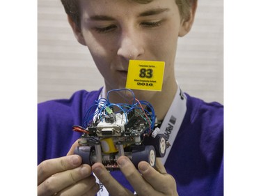 Samual Turtle of Allan High School with a little fine tuning of his robot preparing to due battle at the 8th annual Polytechnic Sumobot Robot Rumble,  April 14, 2016.