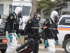 Police move in on the house in question with the Saskatoon Fire department and their Hazmat unit on standby at a situation in the 300 block Avenue K North, April 15, 2016.