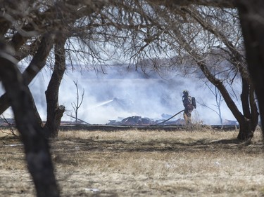 Saskatoon and Warmen firefighters battle a grass fire on an acreage north of Cathedral Bluffs on April 17, 2016.