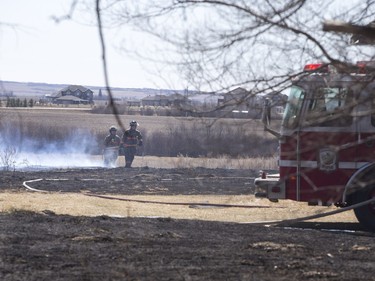 Saskatoon and Warmen firefighters battle a grass fire on an acreage north of Cathedral Bluffs on April 17, 2016.