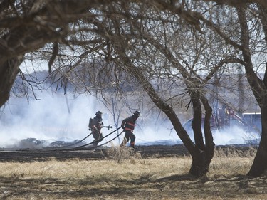 Saskatoon and Warmen firefighters battle a grass fire on an acreage north of Cathedral Bluffs on April 17, 2016.