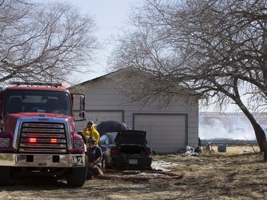 Saskatoon and Warmen firefighters battle a grass fire on an acreage north of Cathedral Bluffs on April 17, 2016.