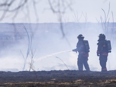 Saskatoon and Warmen firefighters battle a grass fire on an acreage north of Cathedral Bluffs on April 17, 2016.