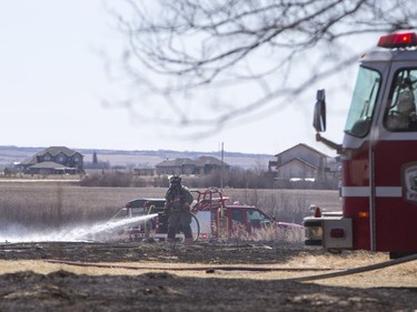 Saskatoon and Warmen firefighters battle a grass fire on an acreage north of Cathedral Bluffs on April 17, 2016.