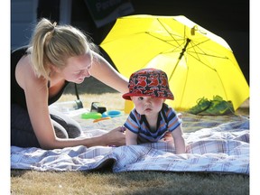 SASKATOON, SASK.; APRIL 18, 2016 - 0419 weather outdoors   Kenzie Bergeron and her son Kingston threw a blanket on their front lawn and soaked up the gorgeous sunshine in warm weather conditions for the middle of April, April 18, 2016 (GORD WALDNER/Saskatoon StarPhoenix)