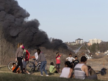 Thousands came out and lined the nearby parks and streets at a huge fire in an auto wrecking yard at Avenue P South and 14th Street West which was burning intensely for firefighters who battled it with their ladder truck, April 19, 2016.