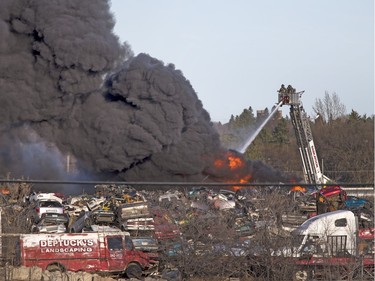 Thousands came out and lined the nearby parks and streets at a huge fire in an auto wrecking yard at Avenue P South and 14th Street West which was burning intensely for firefighters who battled it with their ladder truck, April 19, 2016.