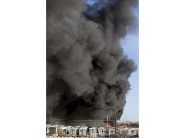An auto wrecking yard at Avenue P South and 14th Street West was burning intensely for firefighters who battled it with their ladder truck, April 19, 2016.