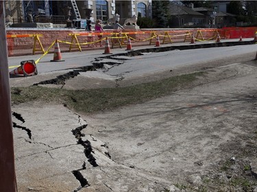 The road and ground in the 800 block of Saskatchewan Crescent is slipping and crumbling as pedestrians make their way around the barricade, April 19, 2016.