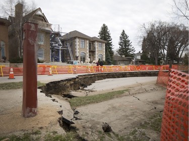 A section of Saskatchewan Crescent East, near 16th Street east is blocked off after a larger area succumbed to erosion on April 24, 2016.