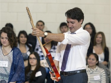 Prime Minister Justin Trudeau was given a hand crafted guitar built by students as a gift during his visit at Oskayak High School in Saskatoon, April 27, 2016.