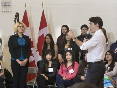 Prime Minister Justin Trudeau answers students' questions, including Tahris Bear, at Oskayak High School after touring the school and the Aboriginal Youth Entrepreneurship Program, April 27, 2016.