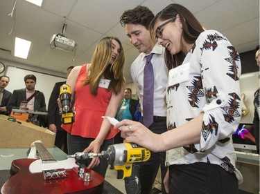 Prime Minister Justin Trudeau was at Oskayak High School in the Aboringinal Youth Entrepreneurship Program where he enjoyed helping Johannah Angus and Kayla Verbonac put together parts of a guitar that was later given to him as a gift, April 27, 2016. The back of the guitar was signed by the students in the class.