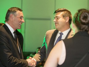 SaskParty candidates Corey Tochor (right) and Don Morgan celebrate at the Sask Party party headquarters in Saskatoon after winning their respective ridings,  April 4, 2016.