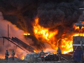 Firefighters appear small in the foreground of this huge fire at Shercom Industries north of Saskatoon.