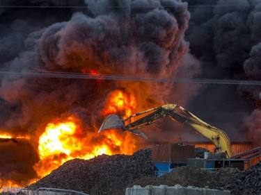 Firefighters appear small in the foreground of this huge fire at Shercom Industries north of Saskatoon.