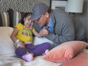 Emil Hyman helps his daughter, Shaylin, pick out her new bedroom. The family were the winners in the Hospital Home Lottery.