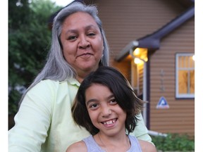 Raven Sinclair, an expert on the sixties scoop, with her daughter Mercedes outside their home in Saskatoon. File photo