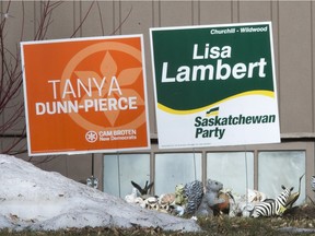 Competing election signs show conflicting opinions within a home in the Churchill Wildwood area.