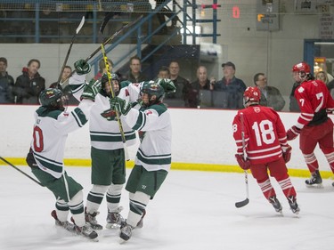 L-R: Winnipeg Wild forwards Caiden Daley, Brendan Keane, and Brett Namaka celebrate a goal against the Notre Dame Hounds during a Telus Cup west regional game at Rod Hamm Memorial Arena in Saskatoon, March 31, 2016.