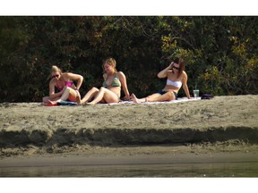 File Photo. SASKATOON, SASK.--SEPT. 23, 2014--Sunbathers enjoy the unseasonally warm weather on the east bank of the South Saskatchewan River north of the Broadway Bridge on September 23, 2014 in Saskatoon. {RICHARD MARJAN/STARPHOENIX}