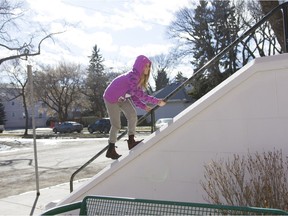Amalia Janzen climbs a railing on Grace-Westminister United Church during a sunny afternoon in Saskatoon, Saskatchewan on Sunday, March 13th, 2016. (Kayle Neis/Saskatoon StarPhoenix)
