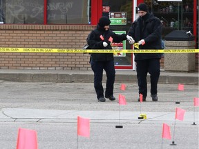 Members of the Saskatoon police major crimes and forensic identification units investigate after a man died in the Sutherland area on April 24, 2016 in Saskatoon.