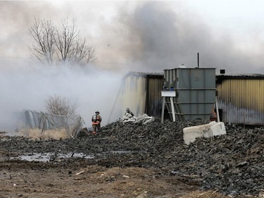Firefighters continue to battle a fire at Shercom Industries in the North Corman Industrial Park north of Saskatoon, April 5, 2016. The fire has been burning all night and the fuel of recycled rubber products has been hard to extinguish.