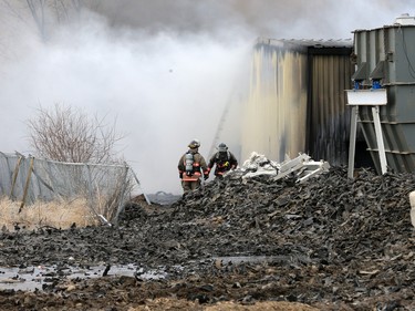 Firefighters continue to battle a fire at Shercom Industries in the North Corman Industrial Park north of Saskatoon, April 5, 2016. The fire has been burning all night and the fuel of recycled rubber products has been hard to extinguish.