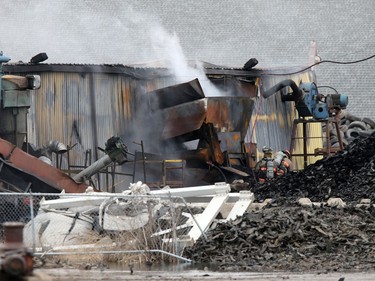 Firefighters continue to battle a fire at Shercom Industries in the North Corman Industrial Park north of Saskatoon, April 5, 2016. The fire has been burning all night and the fuel of recycled rubber products has been hard to extinguish.