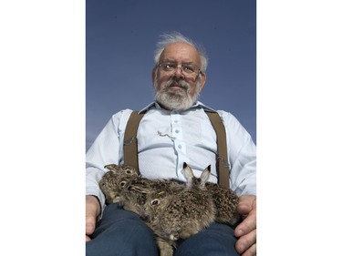 John Polson at Diefenbaker Park with 12 baby hares he rescued from the city, April 27, 2016.