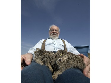 John Polson at Diefenbaker Park with 12 baby hares he rescued from the city, April 27, 2016.