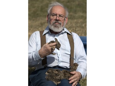 John Polson at Diefenbaker Park with 12 baby hares he rescued from the city, April 27, 2016.