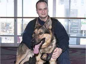 K-9 Kato and handler Cst. Eddie Panamaroff wait to receive their badge at a swearing-in ceremony.