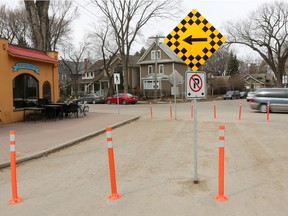 Temporary barriers block off 14th Street East between Landowne Avenue and Temperance Street. More than a dozen residents have written to city council asking the barriers be removed.