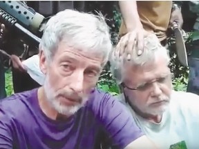 Two Canadians kidnapped in the southern Philippines -  Robert Hall, 50, (in purple on left) and John Ridsdel, 68, who were abducted Sept. 21 from a marina on Samal Island.