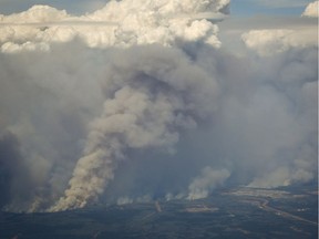 Wildfires in Northern Alberta are menacing the Saskatchewan border and have been sending smoke east, placing certain parts of Saskatchewan under air quality warnings.