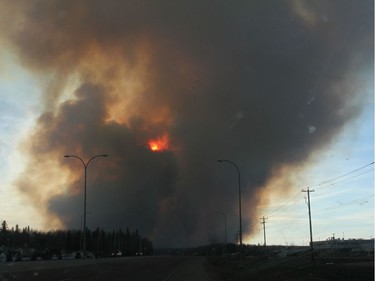 A forest fire burns as viewed from Highway 69 south of Fort McMurray, Alberta, May 1, 2016.