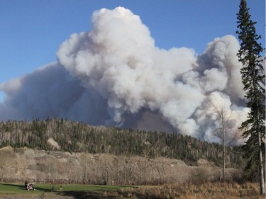 A forest fire burns as viewed from Real Martin Drive in Fort McMurray, Alberta, May 1, 2016.