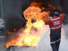 A Rabbit Lake Mine Rescue (Cameco) member controls a fire during the mining emergency skills competition at Evraz Place in Regina.