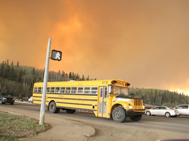 A school bus evacuating children from a school in the subdivision of Abasand drives through an intersection in Fort McMurray, Alberta, May 3, 2016.