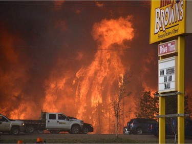 A wall of fire rages outside of Fort McMurray, Alberta, May 3, 2016. Raging forest fires whipped up by shifting winds sliced through the middle of the remote oilsands hub city of Fort McMurray Tuesday, sending tens of thousands fleeing in both directions and prompting the evacuation of the entire city.